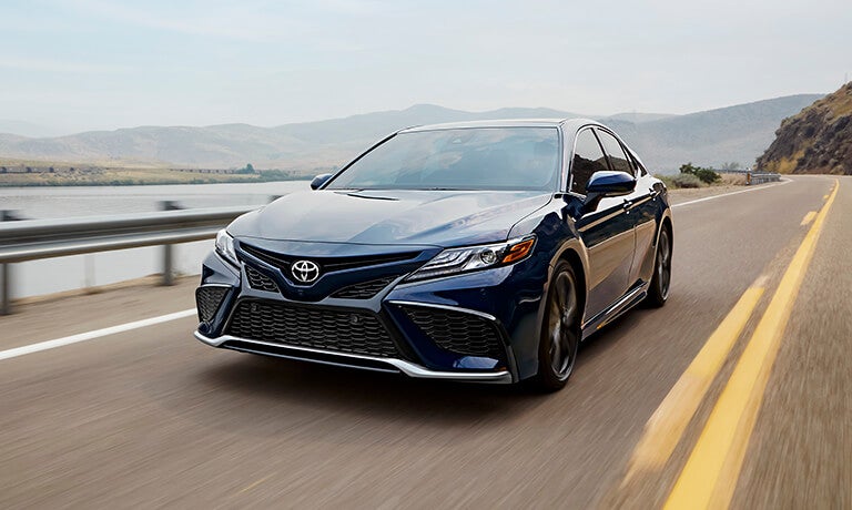 2023 Toyota Camry exterior driving by lake